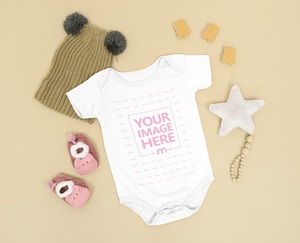 Baby Onesie Mockup Laid Over a Brown Background