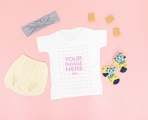 Baby Shirt Mockup Laid on Floor Close by A Baby Pants