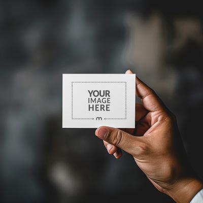 Business Card Mockup Held By a Person on Dark Background