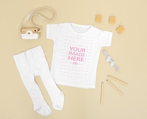 Flatlay Mockup of a Baby Onesie With a Pants Beside it