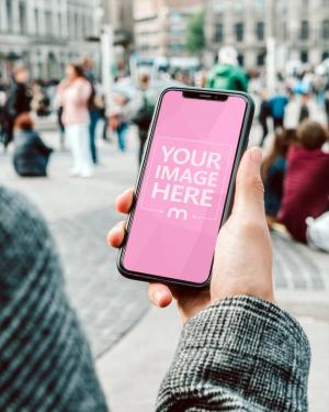 Holding iPhone in Hand Mockup