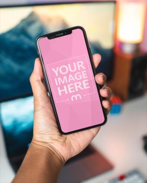 Man Holding iPhone X in Hand Mockup