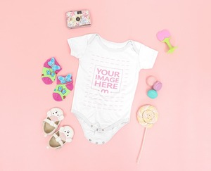 Mockup of a Baby Onesie Surrounded With Girly Accessories