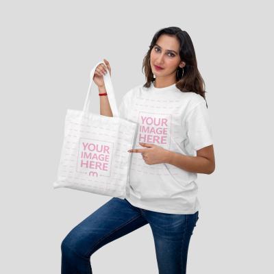 Mockup of a Tote Bag and Shirt Featuring a Woman Pointing to the Bag