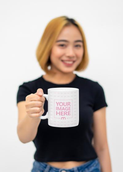 Mug Mockup With a Woman Showcasing the Mug