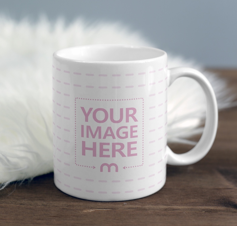 Mug on Wood Desk Near Fur Blanket Mockup preview image