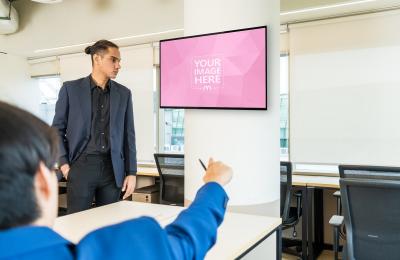 Office Workers Looking at TV Screen Mockup in Meeting Time