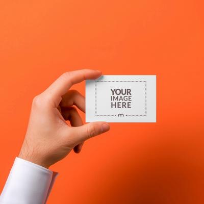 Professional Business Card Mockup in Hand on Orange Background