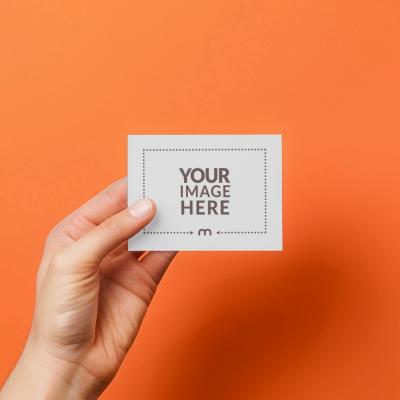 Realistic Hand Holding Business Card Mockup on Colorful Backdrop