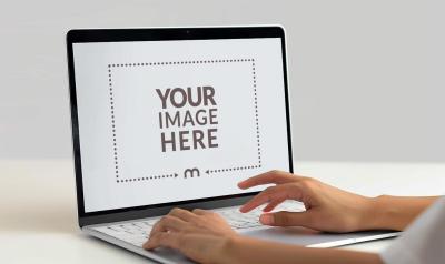 Realistic Laptop Mockup Featuring Typing Hands