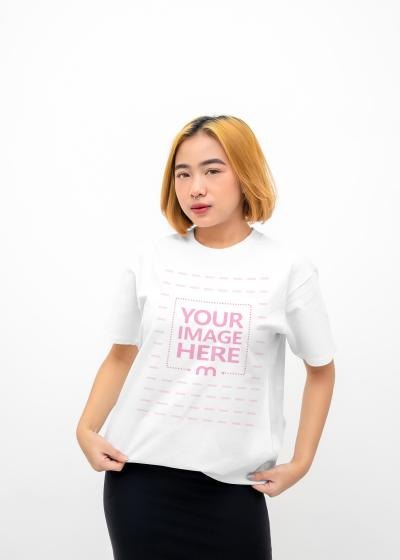 Shirt Mockup With a Woman Holding Her Shirt With Both Hand