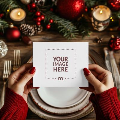 Top View of Christmas Invitation Card Mockup Held by Woman