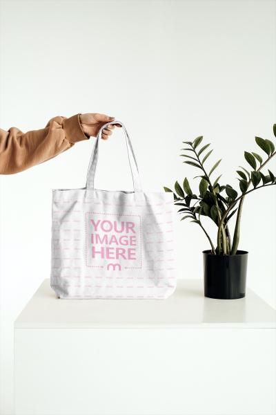 Tote Bag Mockup with Flower on Table PSD