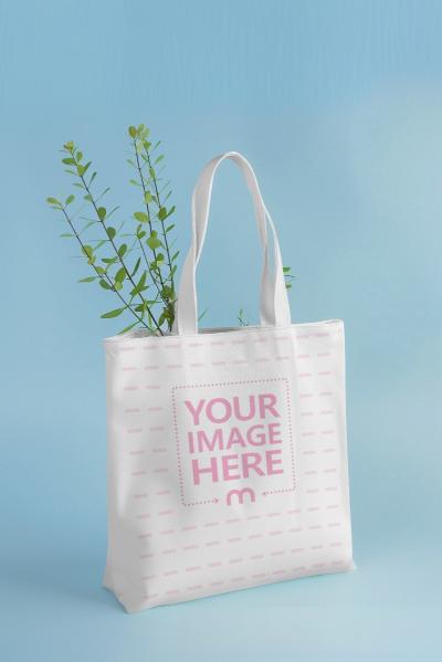 Canvas Tote Bag Mockup with Green Leaves and Blue Background