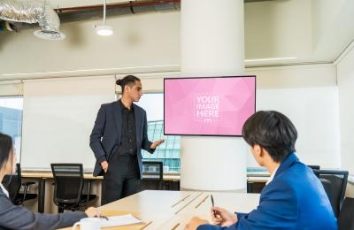 TV Screen Mockup During Office Meeting with Workers