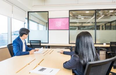 Two Person Meeting in Office with Presentation Screen Mockup