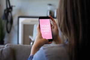 Woman Browsing on a Black Smartphone