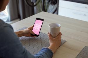 Woman Drinking Coffee and Browsing on Smartphone